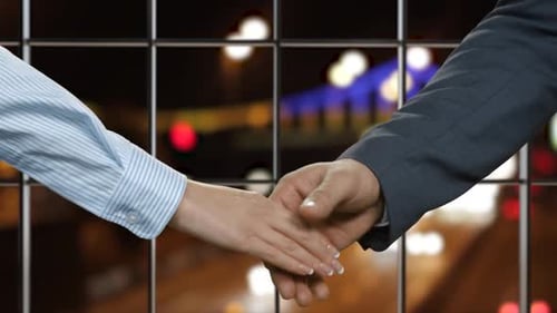 Business Handshake with City Night Lights Background