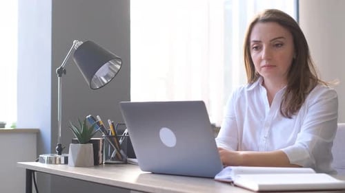 Woman Office Manager Working in the Office Work Woman in the Office Sitting at the Laptop