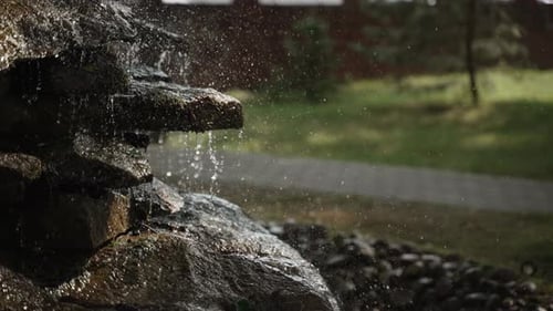 Water Falls Over Rocky Cascade of Stones Breaking and Creating Splashes