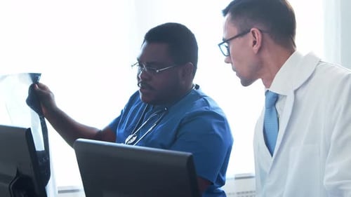Doctor and Surgeon Talking Near Window Medical Workers in Hospital Office Day Light Healthcare
