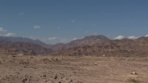 A view of a Mountain in desert from a car on a road, trucking shot