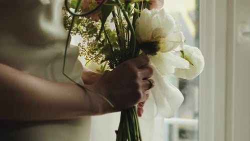 Woman Holding a Delicate Wedding Bouquet Indoors