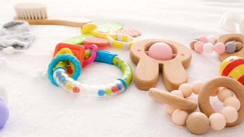 Baby Toys and Accessories on the Bed Selective Focus