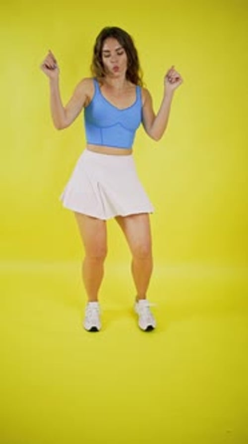 Young Woman Dances in a Blue Top and Skirt