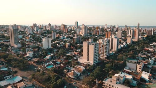 Panoramic view of the sprawling city of Posadas during a breathtaking sunset.