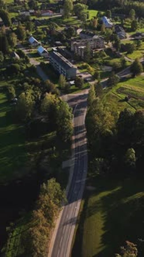 Vertical Drone Ascend Over The Beautiful, Green, Countryside, Village Center Of Nitaure Parish, Cesi