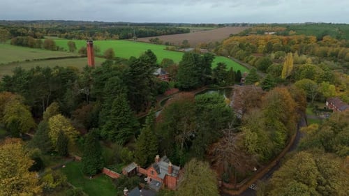 Scenic Aerial View of Old Pumping Station and Surrounding Woodland in Peak Autumn Colours UK