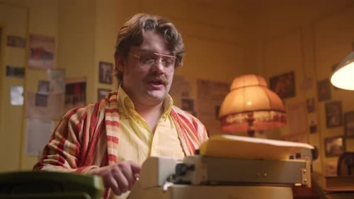 Man Typing on Typewriter in Office Setting