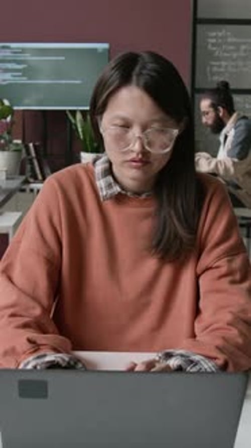 Timelapse of Geeky Asian Woman in Glasses Working on Code at IT Company