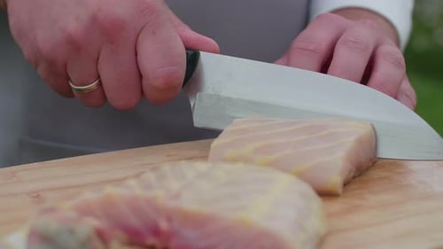 Raw Fish Being Cut with a Knife