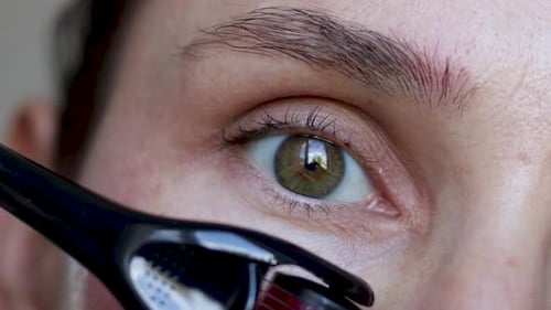 woman eye close up remove pluck eyebrows hair or massaging under with derma roller