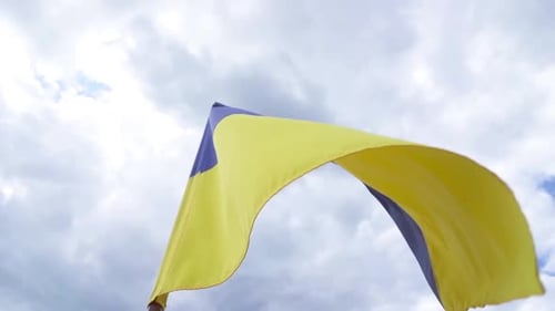 Flag Waving in the Wind Against Sky