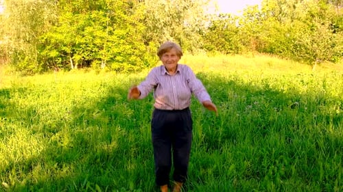 Old Woman Doing Exercises in the Park Selective Focus