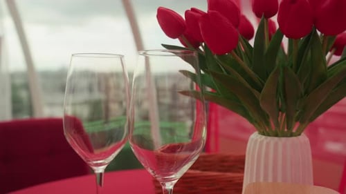 Romantic Table Setting with Red Tulips and Wineglasses