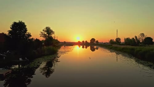 Serene Peaceful Sunrise Drone Aerial Shot over reflective lake with birds chirping