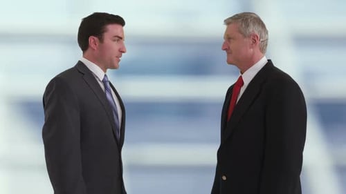 Businessmen Talking and Shaking Hands in Modern Office