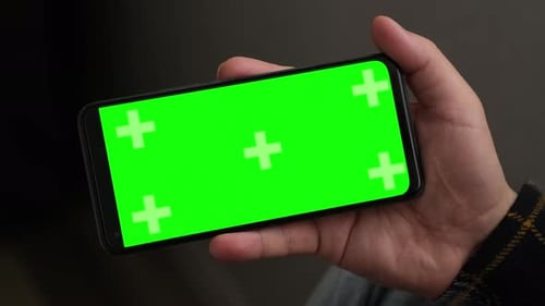 Closeup Man Hand is Holding Chroma Key Green Screen in Horizontal Position