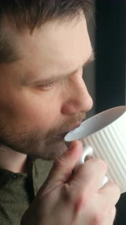 Thoughtful Bearded Man Drinking Morning Coffee Close Up