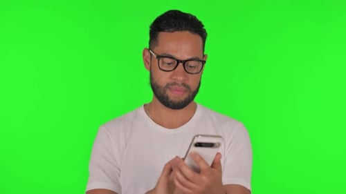Man using Phone on Green Background