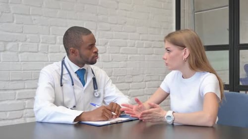 Doctor Consults with Patient in Office Setting