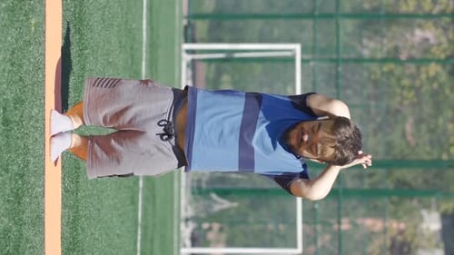 Man Stretching Before Exercising on Sports Field