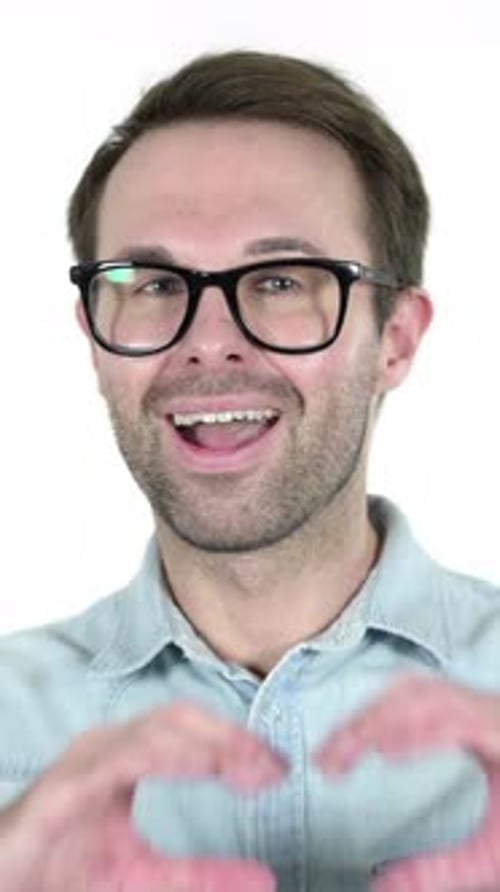 Man Wearing Glasses Makes Heart Shape With Hands