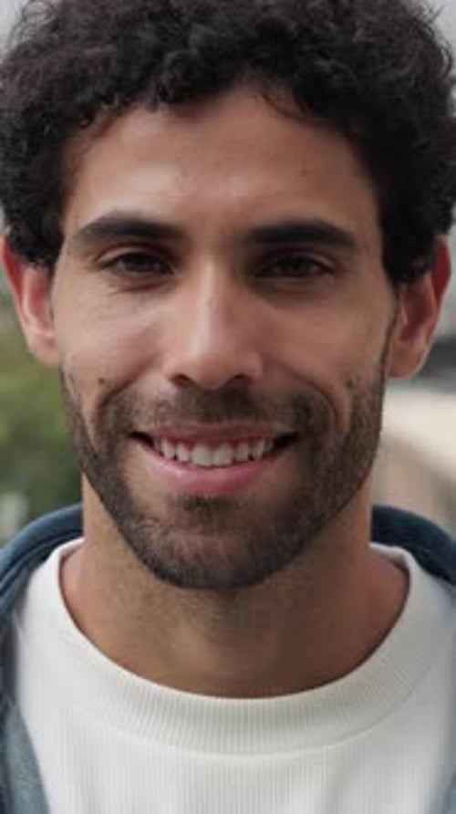 Portrait of Handsome Hispanic Man with Beard Smiles Widely at Urban Park
