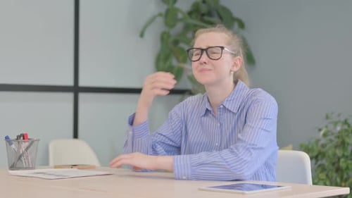 Angry Young Woman in Frustration Sitting in Office
