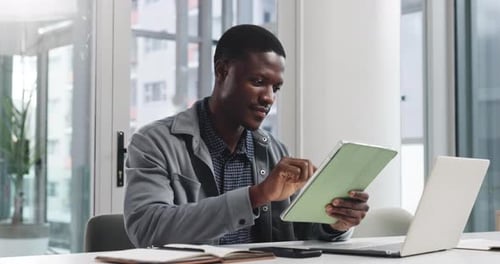 Creative, black man and scroll with tablet in office for research, editor feedback