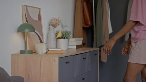 Woman Takes Clothes Out of Dresser in Home