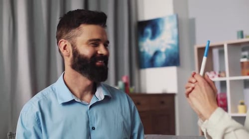 Couple Awaiting Pregnancy Test Results in Living Room