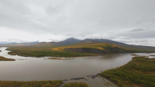 Aerial View of River Valley and Distant Mountains