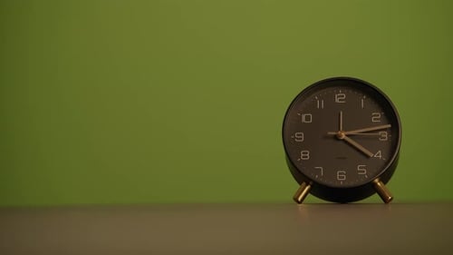 A Minimalist Clock Beautifully Displayed Against a Striking Green Background for Maximum Effect