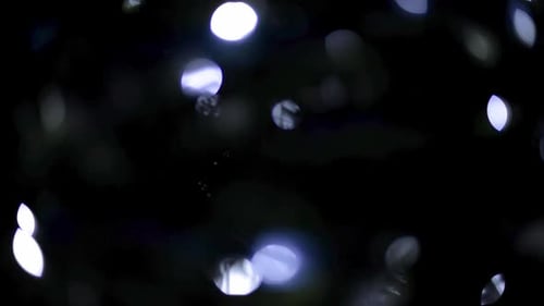 Beautiful blue bokeh lights with a black background flickering. Christmas new year celebration conce