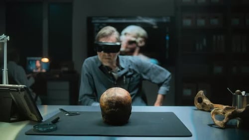 Researcher Wearing Augmented Reality Glasses Examines Skull