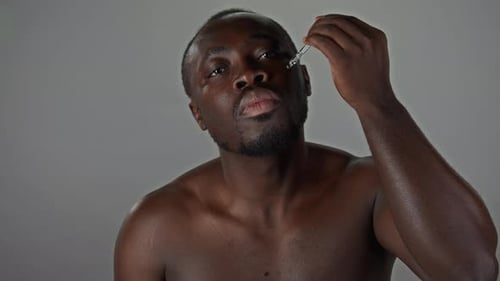 Man Applying Oil To His Face