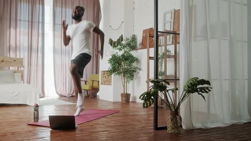 Man Exercising on Yoga Mat at Home