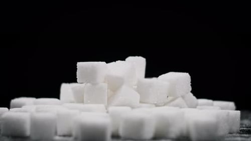 Pile of Sugar Cubes Rotate on a Black Background CloseUp