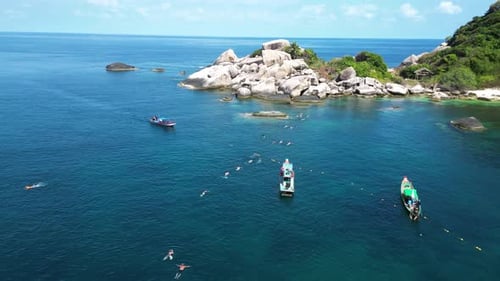 Aerial view of people snorkelling in shark bay on Ko Tao island, Thailand.