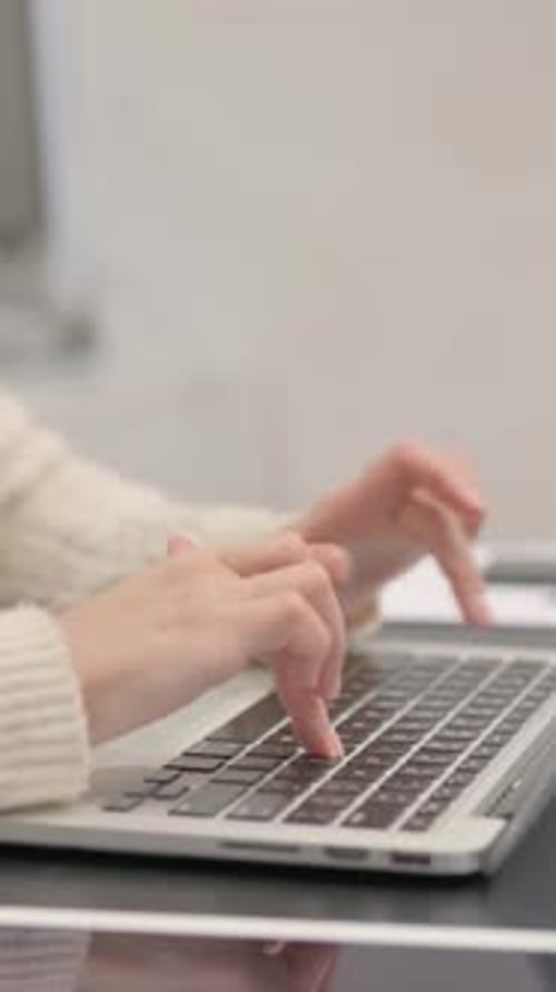 Side View of Female Hands Typing on Laptop