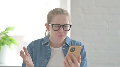 Woman Reacting to Negative News on Phone