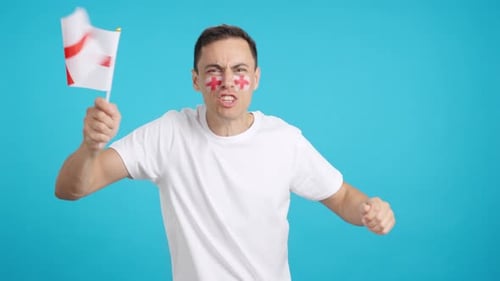 Man Cheering and Waving a Flag on Blue Background