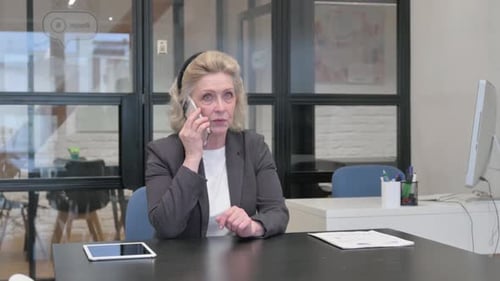 Senior Old Business Woman Talking on phone in Office