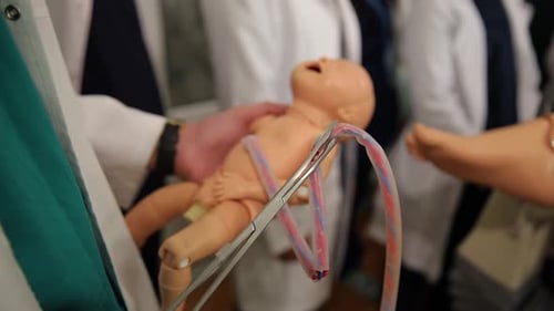 Medical Staff Demonstrating Umbilical Cord Care with Doll