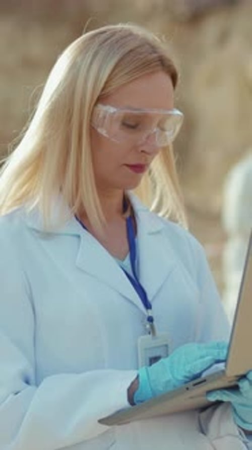 Woman Scientist Working Outdoors on Laptop