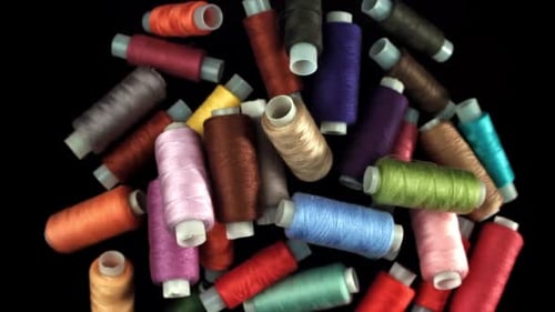 Multicolored Threads Fly on a Black Background Filmed on a Highspeed Camera at 1000 Fps