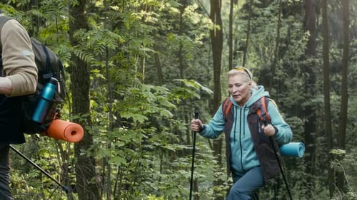 Female Hiker Taking Deep Breath after Climbing on Top of Hill with Husband