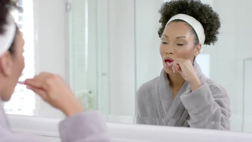 Woman Brushing Teeth in a Modern Bathroom