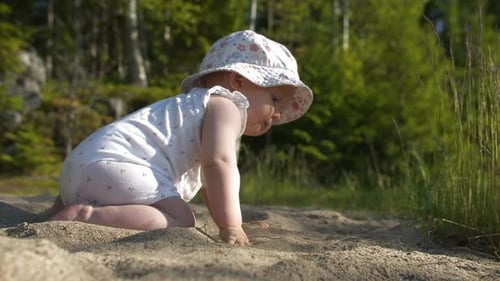Baby Playing in the Sand on a Beach
