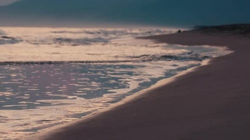 Calm Shoreline with Rolling Waves at Twilight